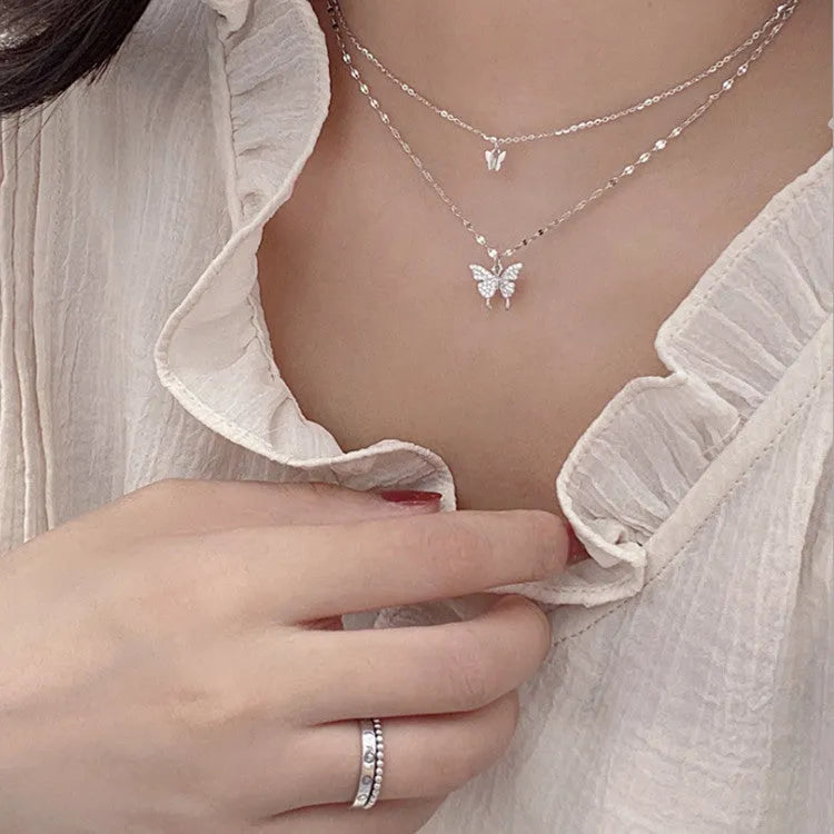 Silver colour double layer clavicle chain necklace with shiny butterfly pendant on copper base