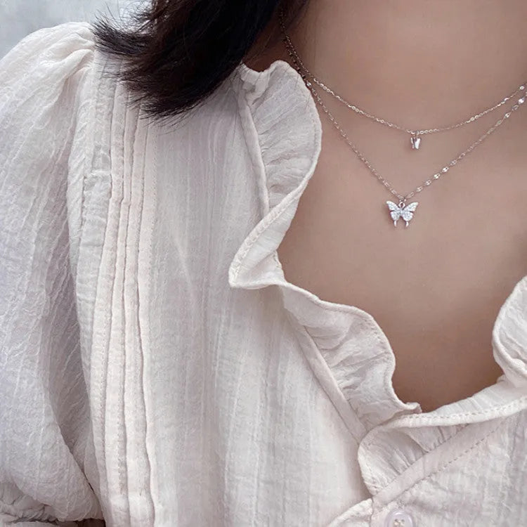 Silver colour double layer clavicle chain necklace with shiny butterfly pendant on copper base