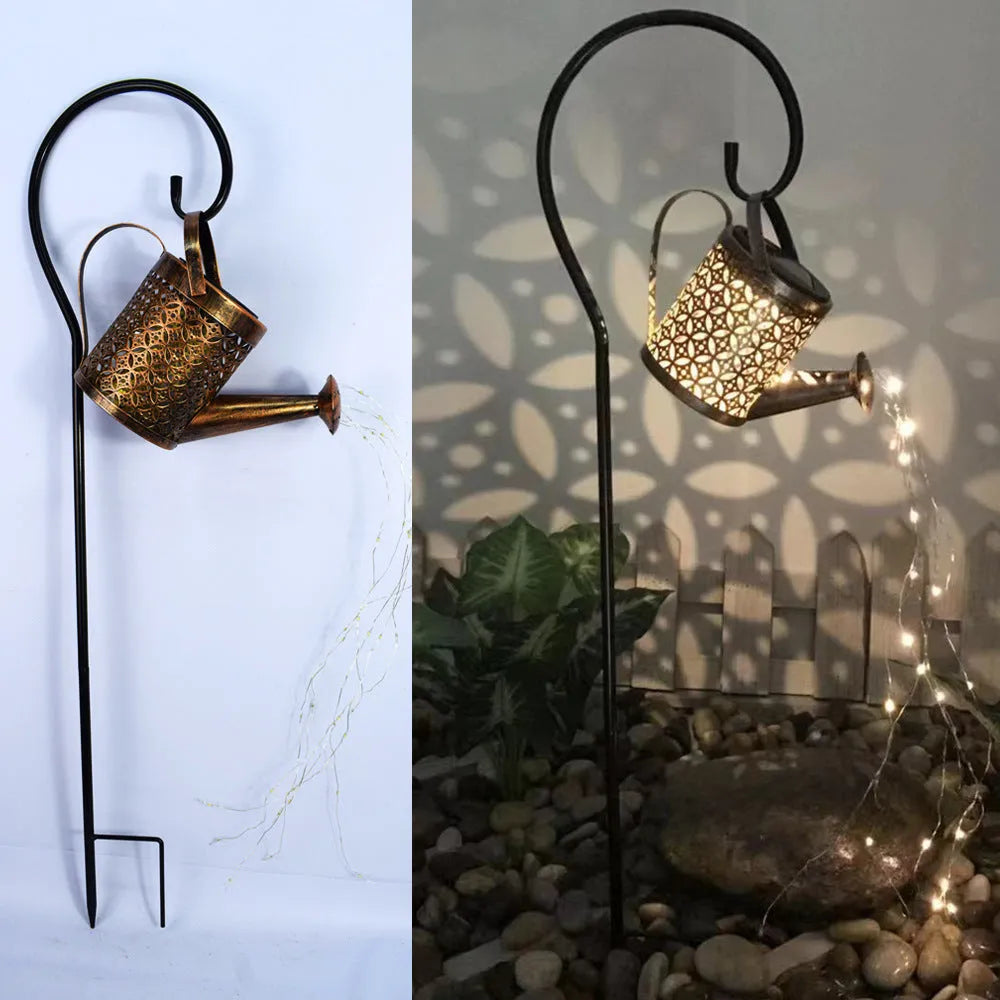 Enchanted watering can solar lamp with warm white star-shaped LED lights in a garden setting