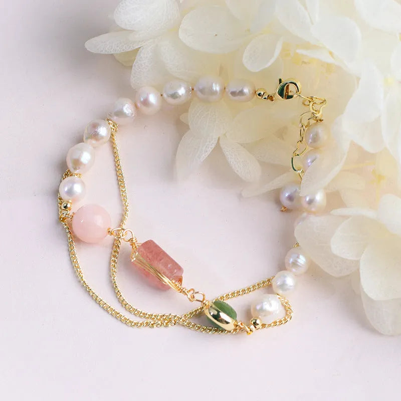 Women's freshwater pearl bracelet with strawberry crystal charms on geometric metal design