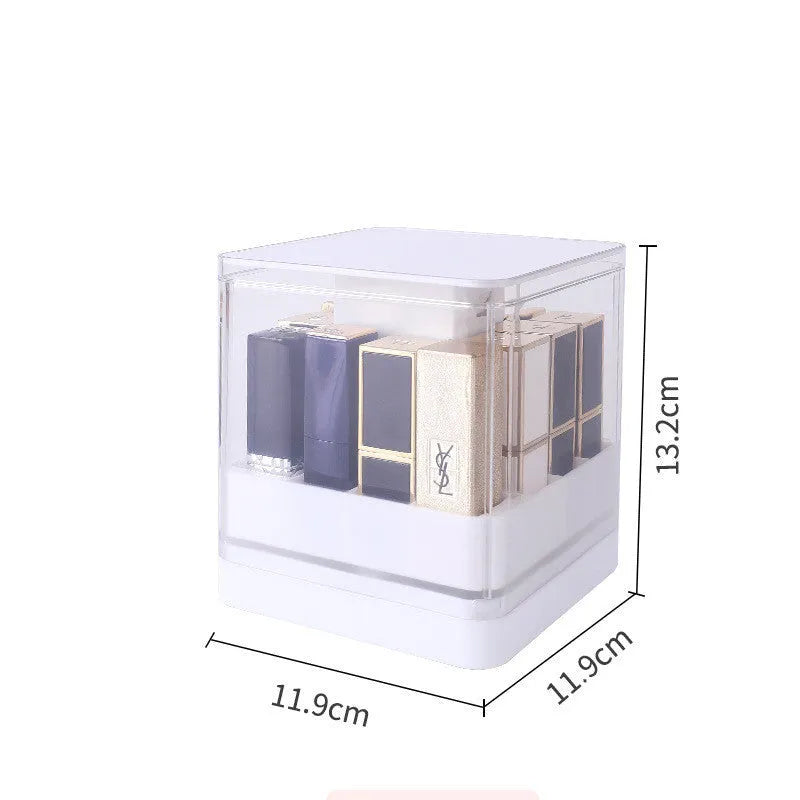 Press lift lipstick storage box with dust cover in pink colour on a desktop