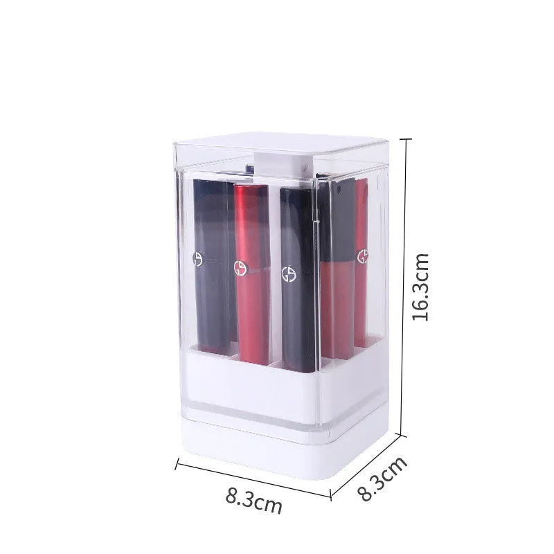 Press lift lipstick storage box with dust cover in pink colour on a desktop