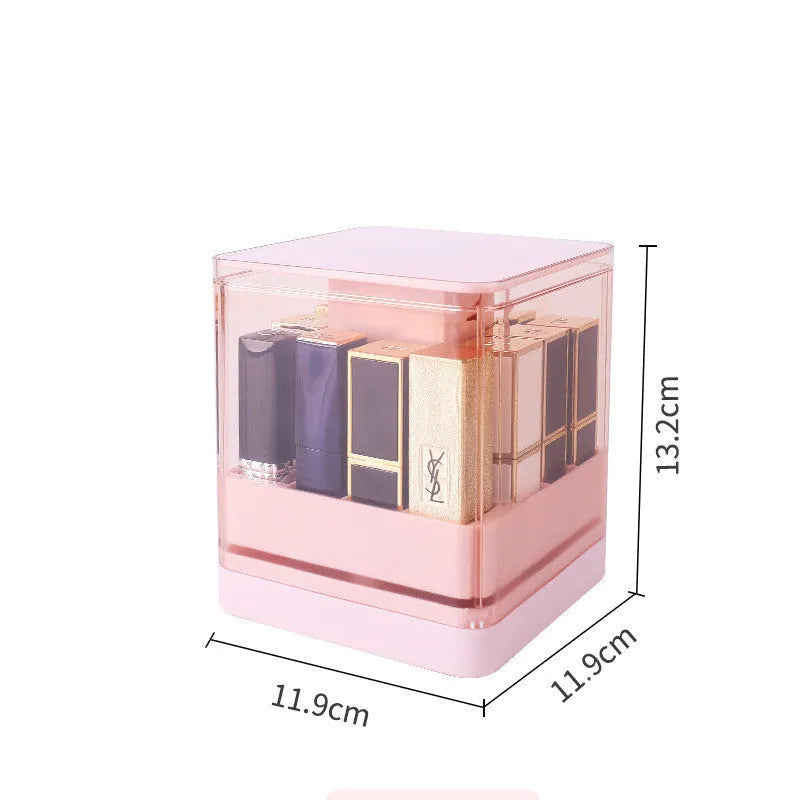 Press lift lipstick storage box with dust cover in pink colour on a desktop
