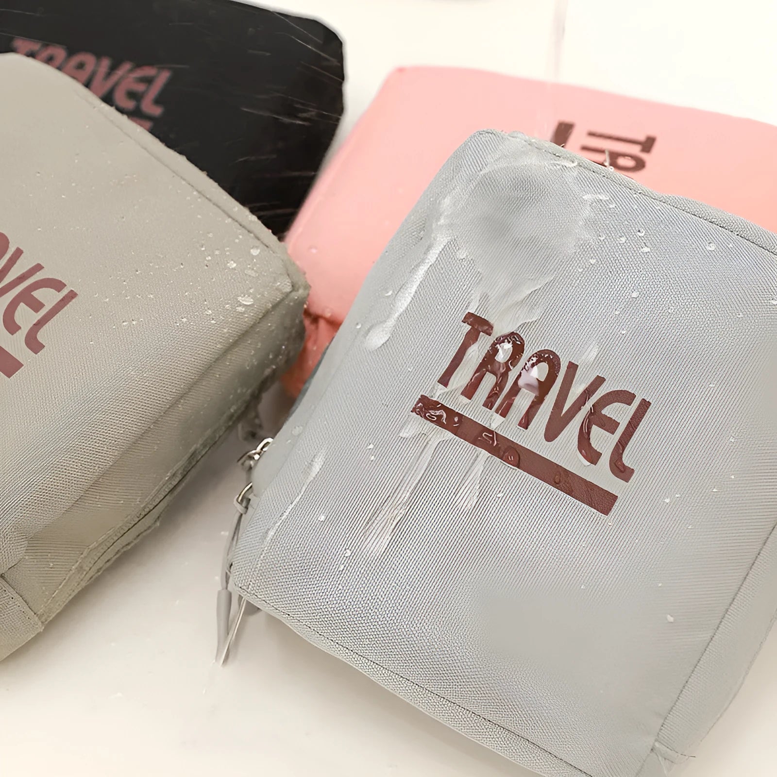 Cube-shaped travel storage bag in Oxford cloth, shown in black, grey, khaki, and pink colour options.