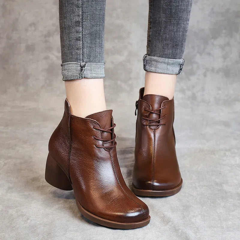 Brown leather women's Martin boots with a round toe and thick rubber sole.