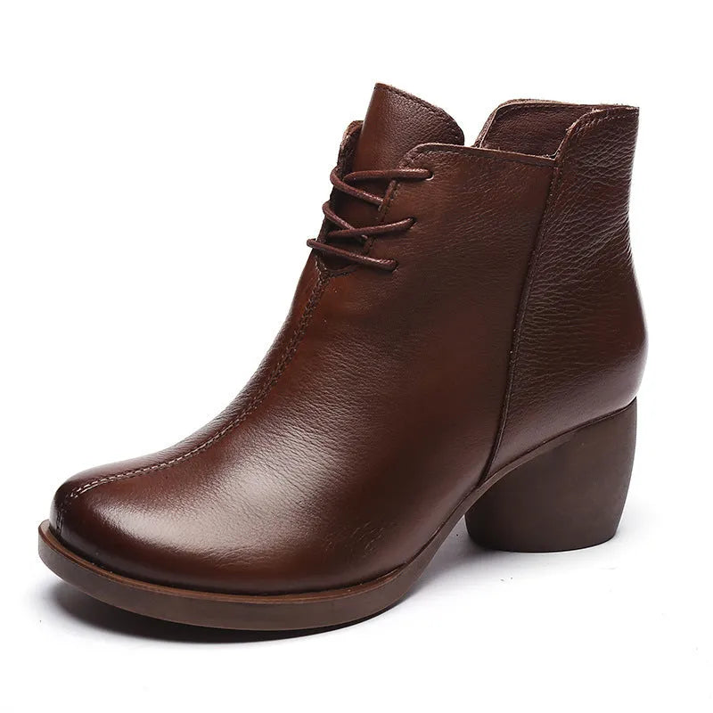 Brown leather women's Martin boots with a round toe and thick rubber sole.