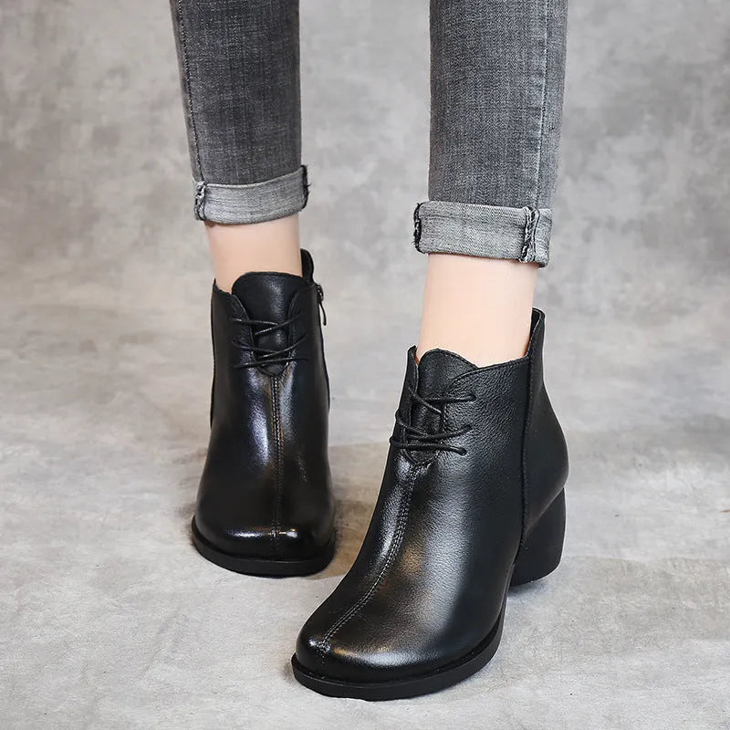 Brown leather women's Martin boots with a round toe and thick rubber sole.