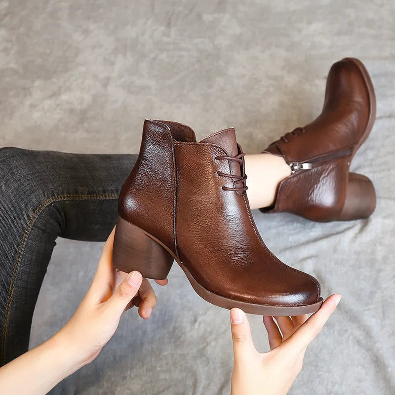 Brown leather women's Martin boots with a round toe and thick rubber sole.