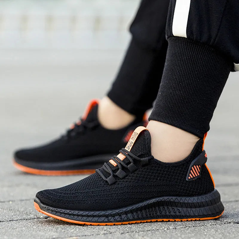 Men's flying woven casual sneakers in orange with white sole, low-top design