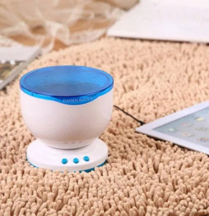Blue ocean theme LED projection lamp for children's rooms on a table.