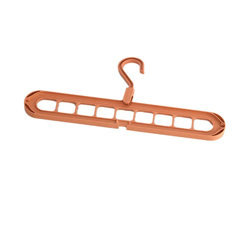 Green plastic nine-hole folding hanger for trousers displayed open and folded flat.