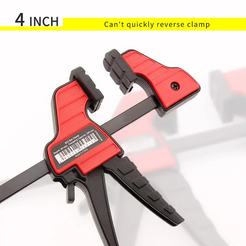 Black plastic woodworking clamp with quick-release lever and soft rubber grip pads
