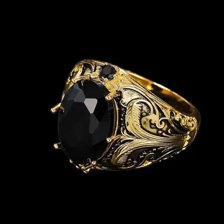 Silver men's wide geometric ring with dark gem-like ornament on a hand.