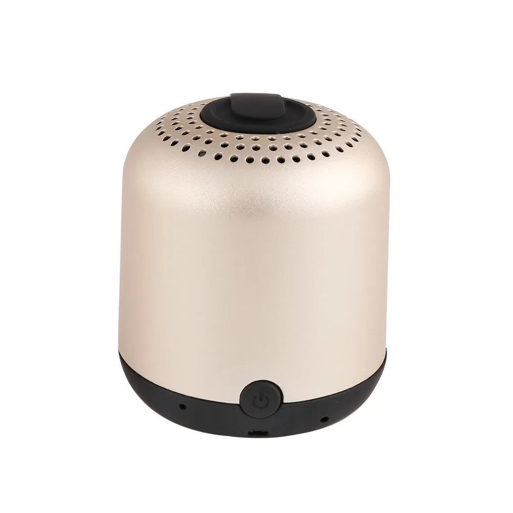 Hieha XQ11 cylinder-shaped mini portable Bluetooth speaker in metallic colour on a table.