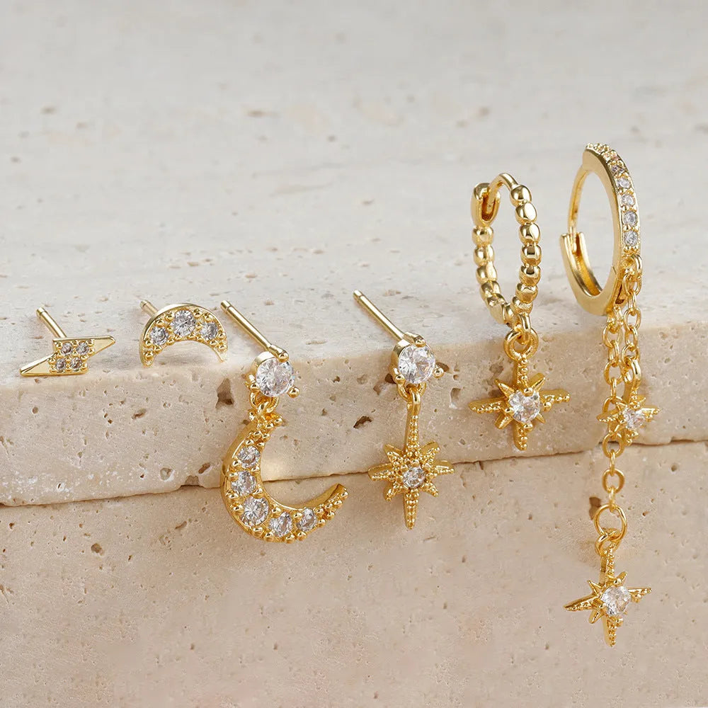 XINGX set of six gold electroplated chain tassel earrings with zircon studs on display