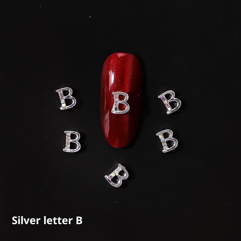 Gold alloy letter A nail ornament charm with crystal detail on a square chain base