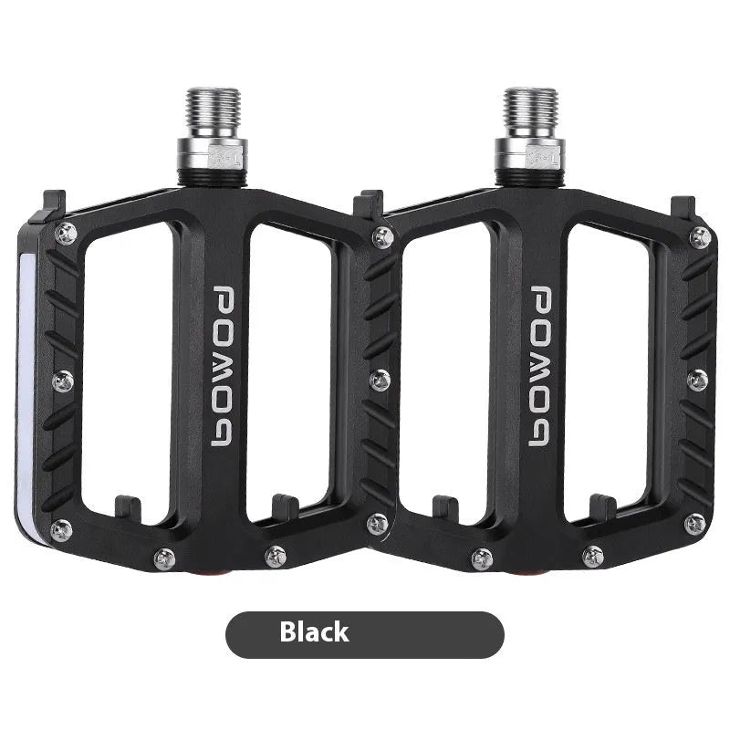 Bicycle pedals with LED lights in purple, black, titanium, red, and gold colour options