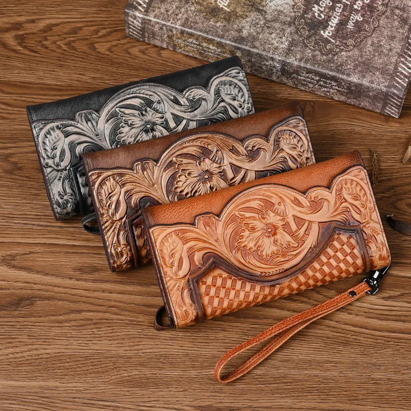 Women's brown tri-fold leather wallet with embossed floral pattern showing open compartments