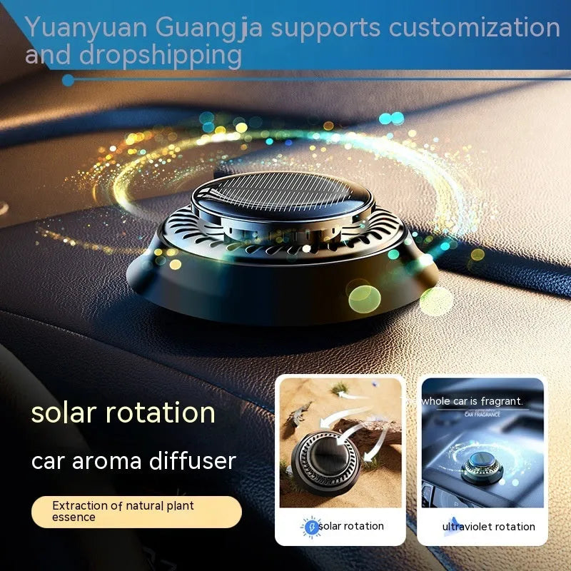 Black solar-powered kinetic double ring car air freshener diffuser on a car dashboard.