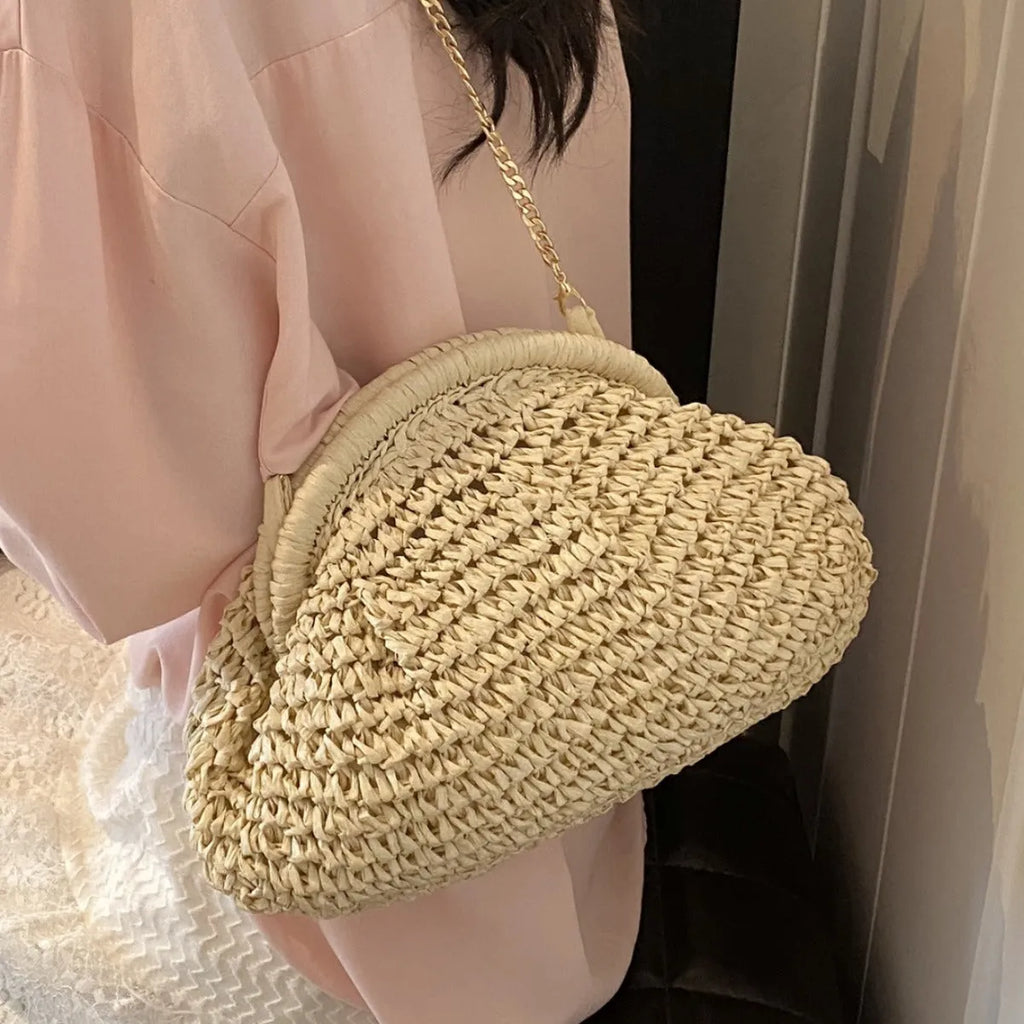 Women's khaki paper straw shoulder bag with chain strap and shell shape showing internal zippered compartment