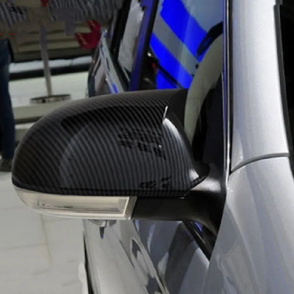 Pair of horn bright black plastic mirror housings for Volkswagen Sagitar with carbon fibre accents.