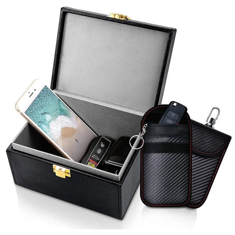 Carbon fibre design RFID shielding box and two matching key cases on a table.
