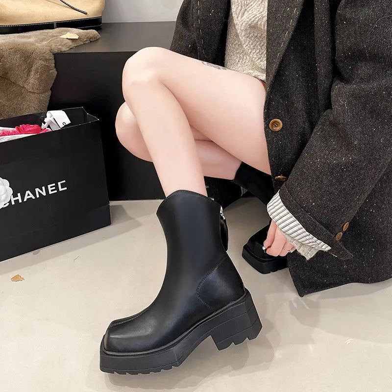 Black women's platform Martin boots with square toe and back zipper, showing mid-calf height.