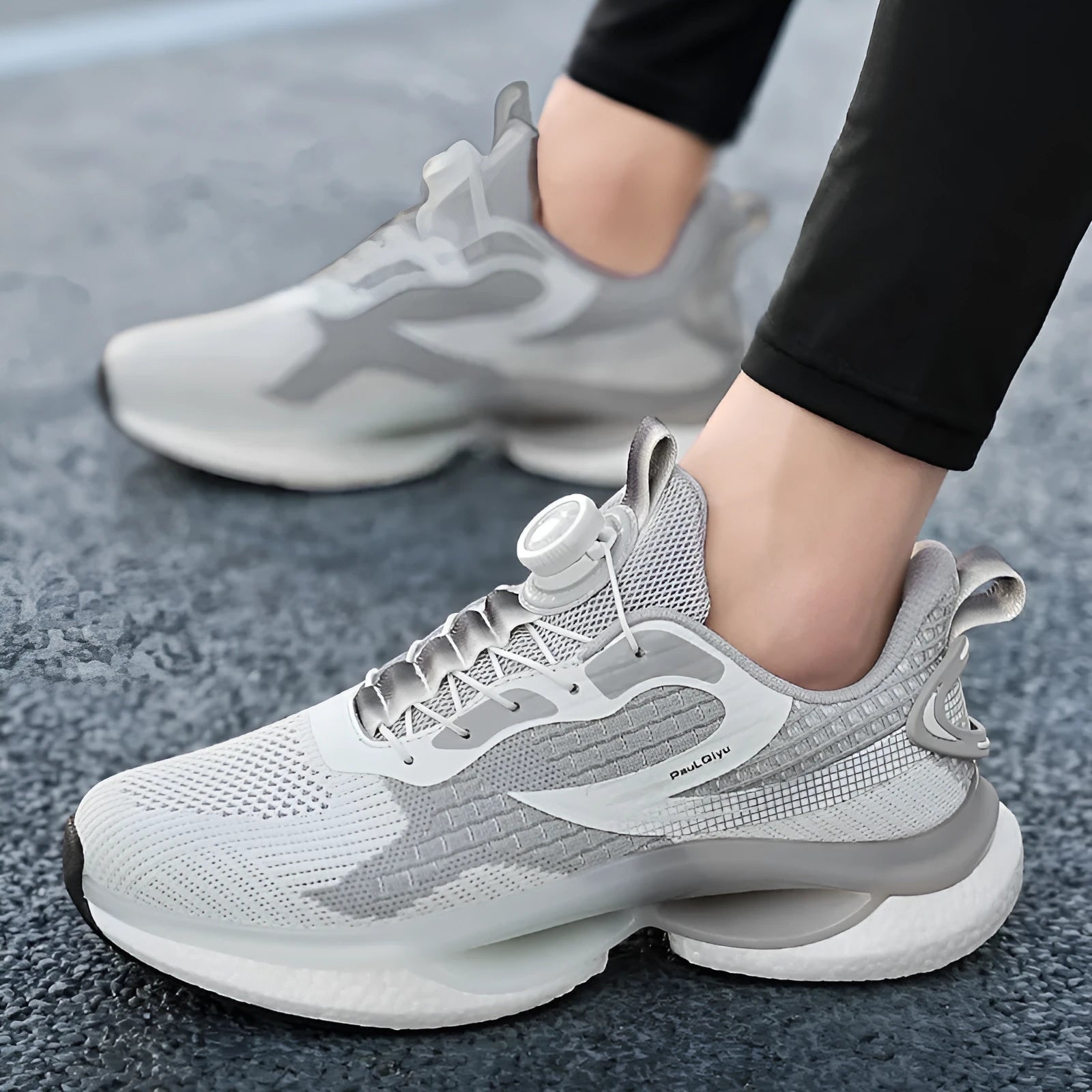 White rotating buckle running shoe with fly-kit mesh upper and low-top design on a solid background.