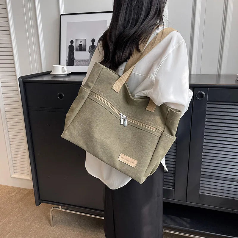Canvas shoulder bag for women with contrast stitching and double shoulder straps, available in grey
