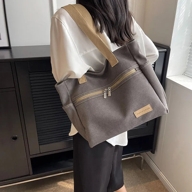Canvas shoulder bag for women with contrast stitching and double shoulder straps, available in grey