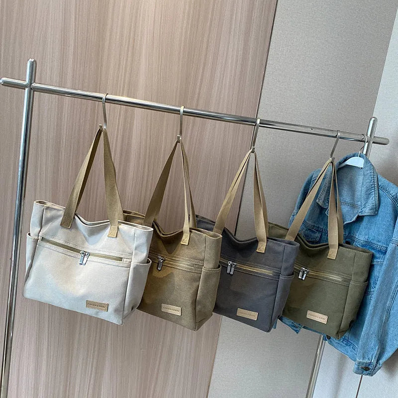 Canvas shoulder bag for women with contrast stitching and double shoulder straps, available in grey