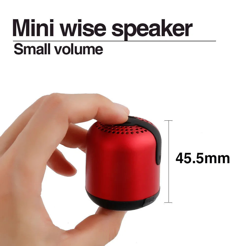 Hieha XQ11 cylinder-shaped mini portable Bluetooth speaker in metallic colour on a table.