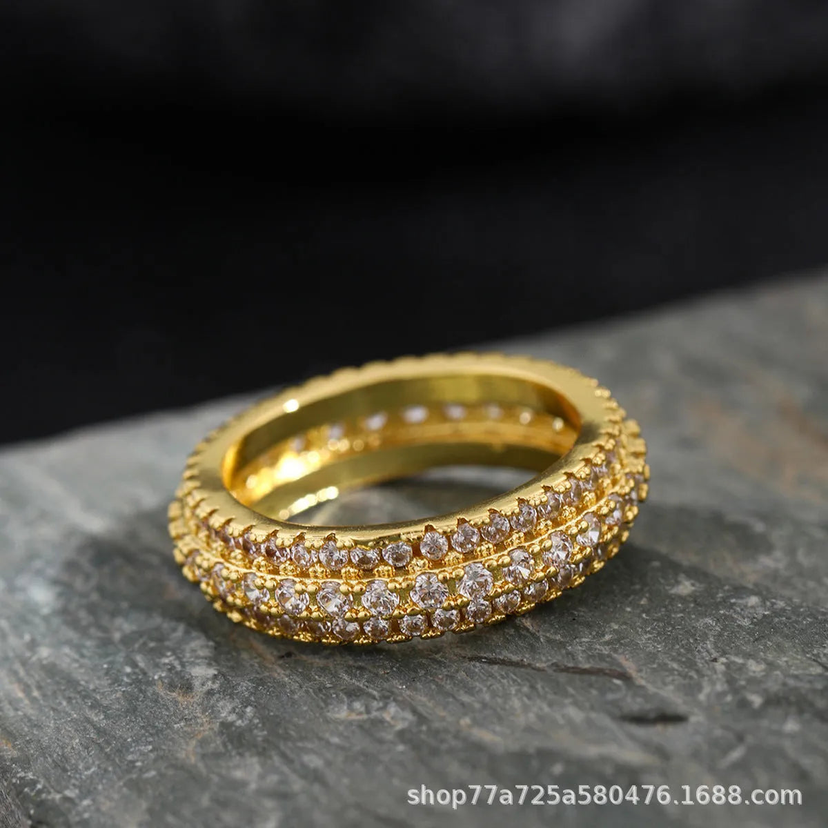 Geometric triangle engagement ring with zircon stone in yellow gold finish on a copper band.