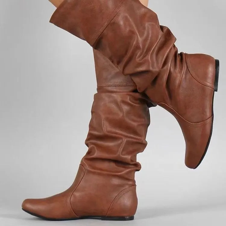 Women's black flat heel long slip-on boots with a round toe and high cylinder length.