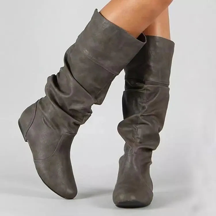 Women's black flat heel long slip-on boots with a round toe and high cylinder length.