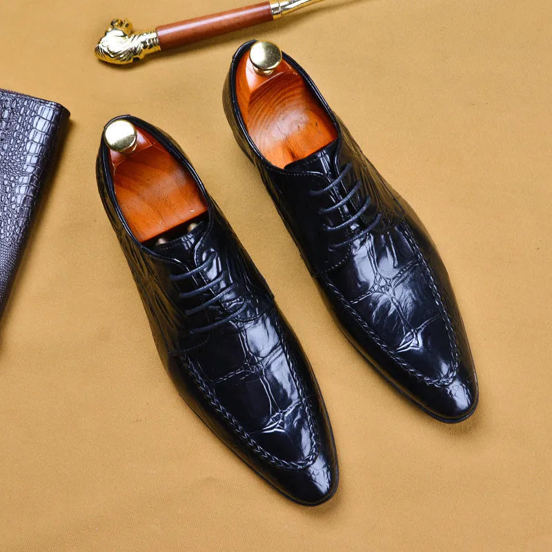 Men's black leather shoes with alligator print texture and a silver horse bit buckle.