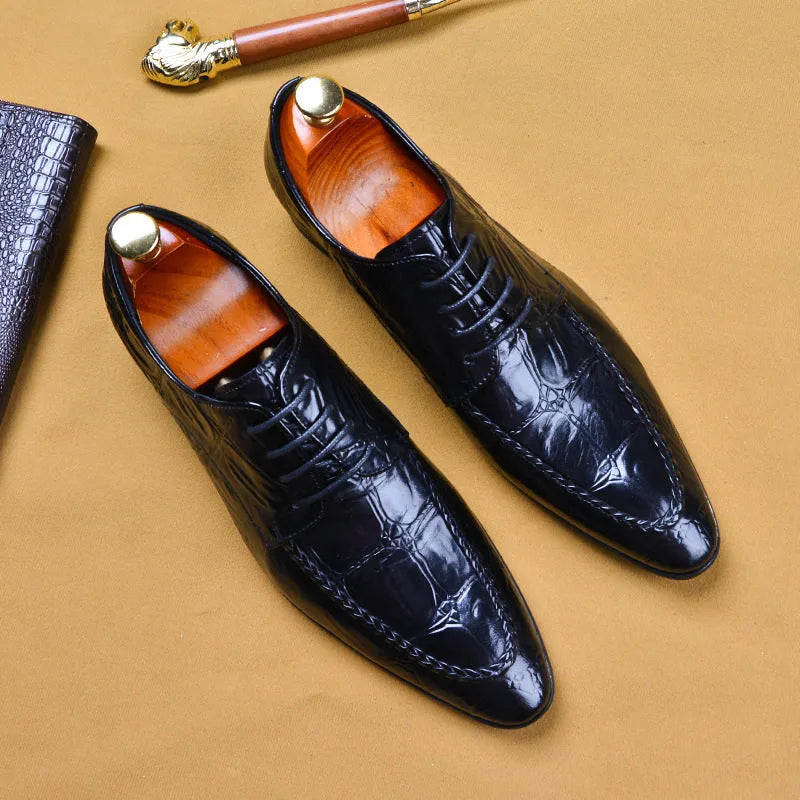 Men's black leather shoes with alligator print texture and a silver horse bit buckle.