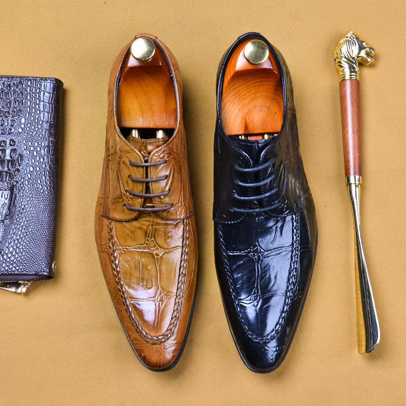 Men's black leather shoes with alligator print texture and a silver horse bit buckle.