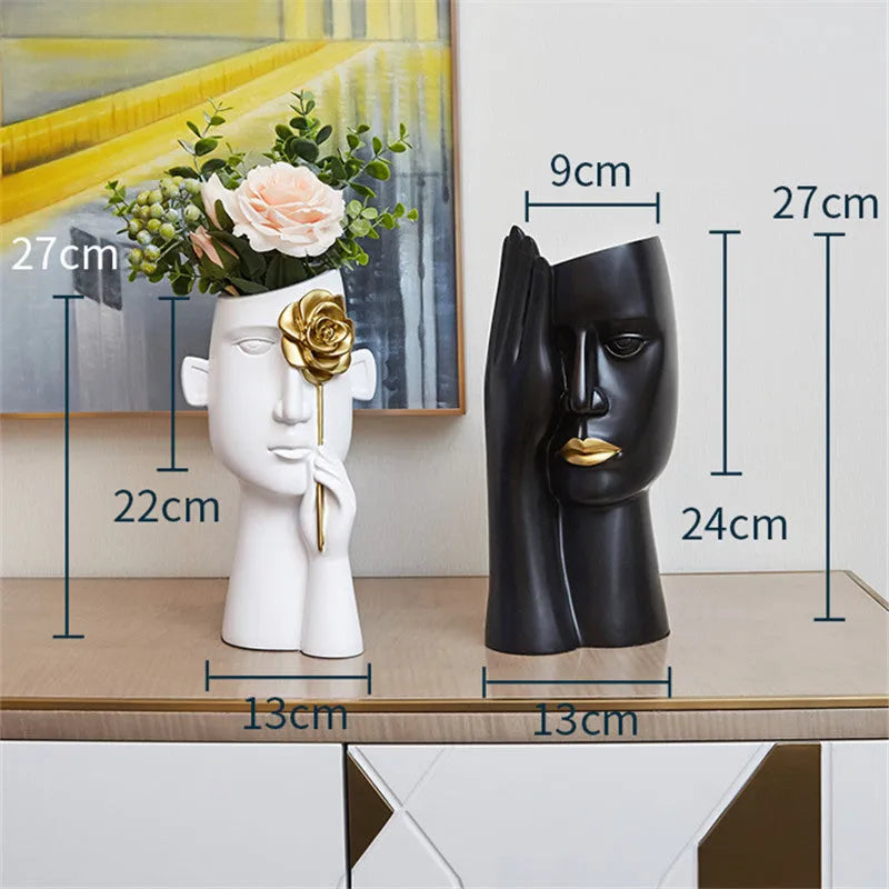 Modern black and white resin vase with sculpted body shape on living room table