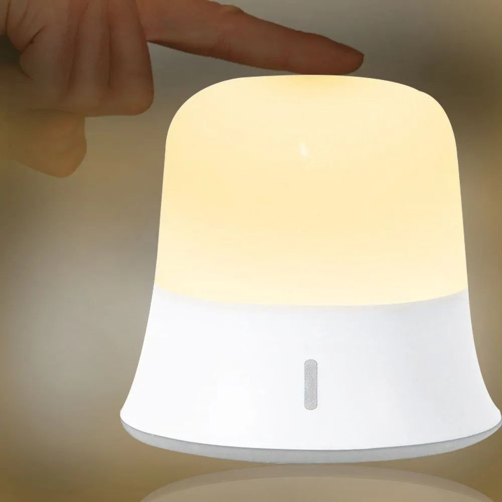 White touch-control bedside night light with motion sensor on a wooden table.
