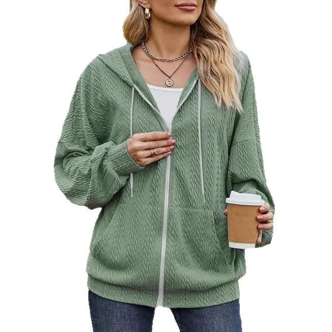 Green women's hooded zipper coat with a loose casual fit on a hanger