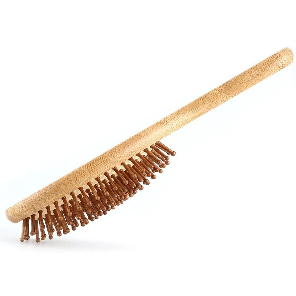 Carbonised bamboo massage comb 66x218mm on neutral background with smooth wooden surface visible