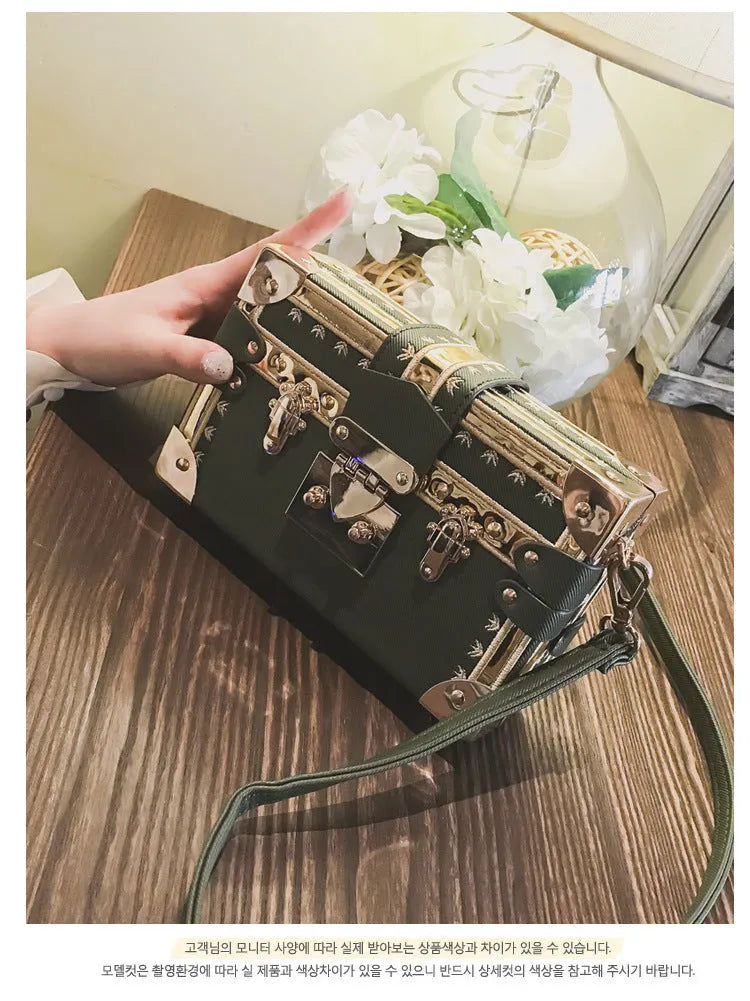 Women's hard PU shoulder bag with flap closure and crossbody strap in black colour with rivet decoration