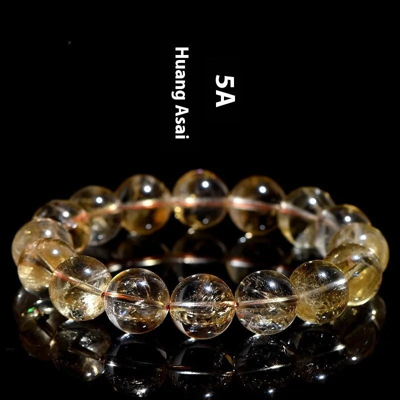 Natural yellow Asestelle citrine bracelet with hand-ground geometry beads on a wrist.