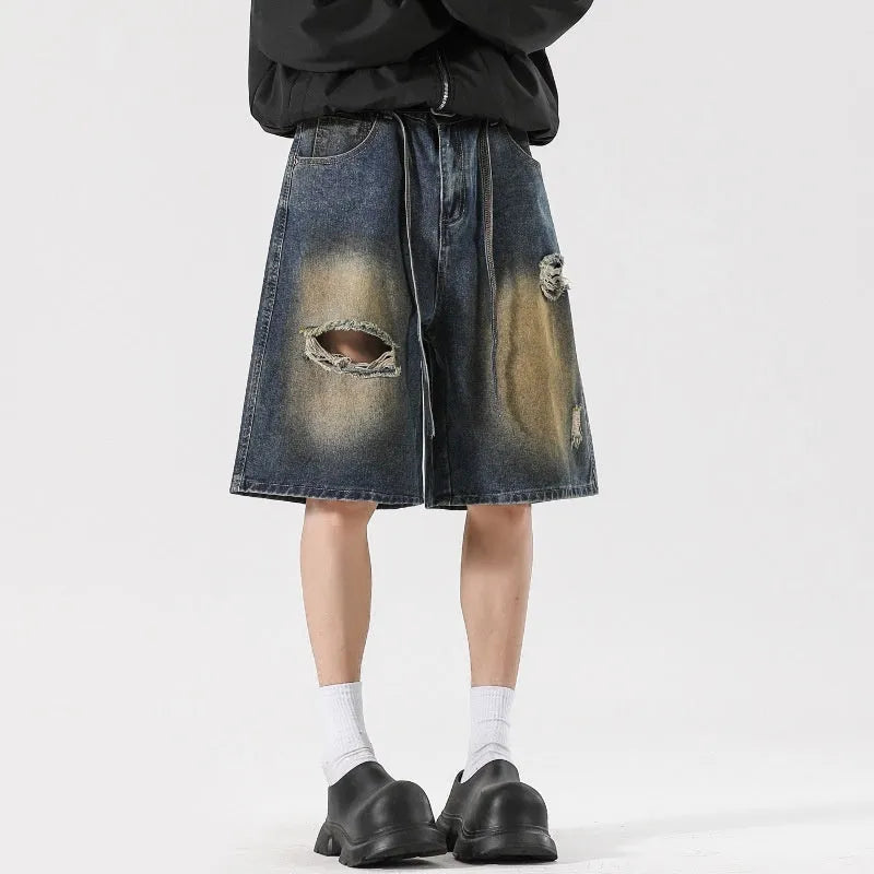 Men's loose-fit ripped jeans in retro blue cotton denim with streetwear styling