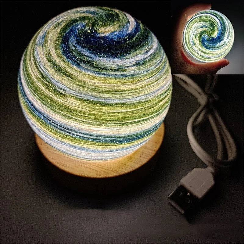 Planet night light with USB cable and base in modern simple design showing spherical shape