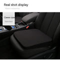 Black car seat cushion for heightening and comfort, shown on a vehicle seat.