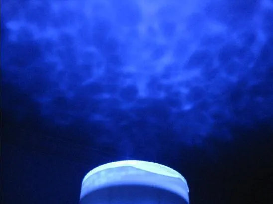Blue ocean theme LED projection lamp for children's rooms on a table.