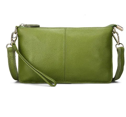 Structured cowhide lady slant bag in apricot colour with hand strap and shoulder strap, showing slim profile.