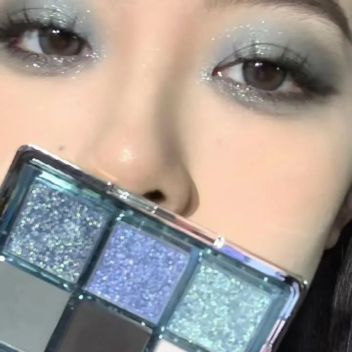 MUGELEEN nine-colour eye shadow palette showing low saturation blue smoked tones with matte and shimmer textures